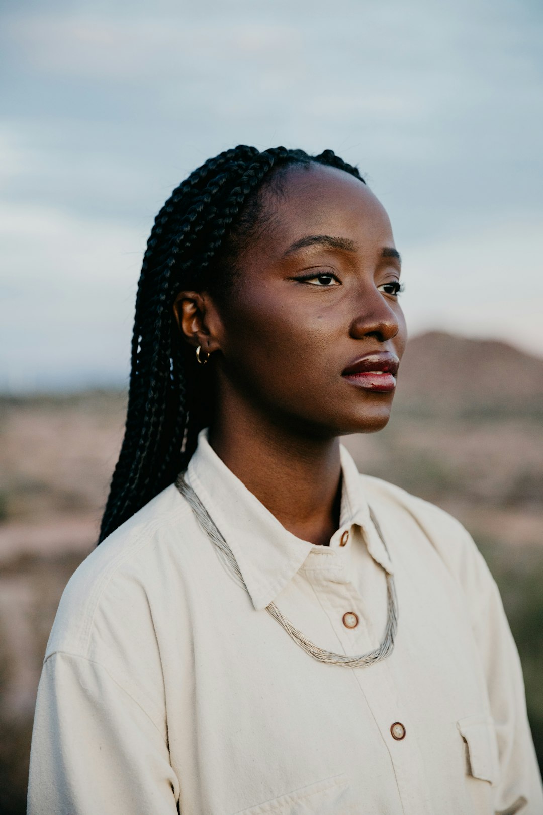 A young woman with braided hair in a desert